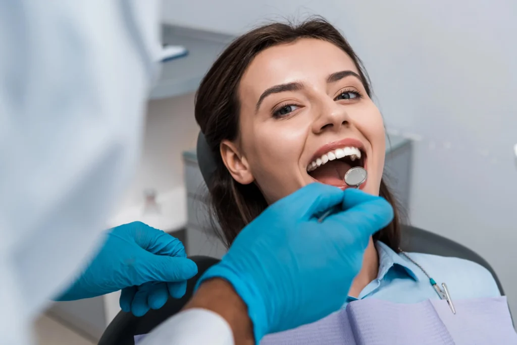 Biological dentist Maryland looking at patient's teeth