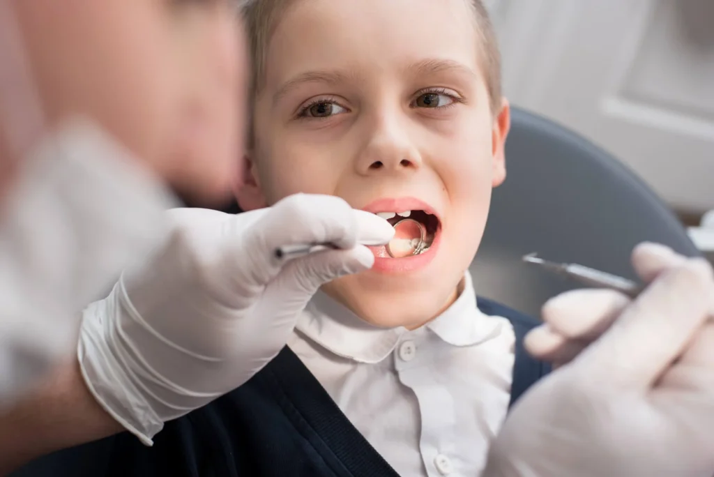 Emergency biological dentist checking patient's tooth