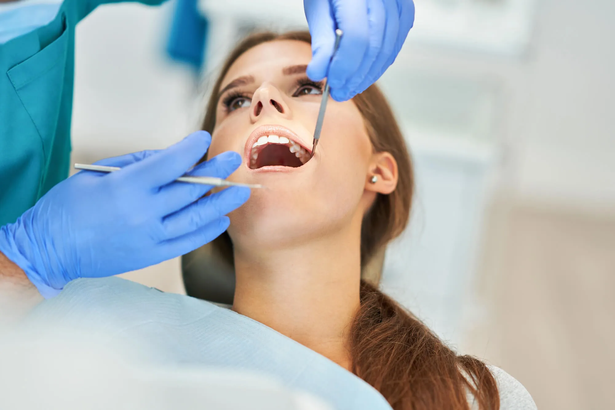 dentist in 20866 checking patient's teeth