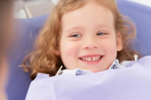child smiling at pediatric holistic dentist in Maryland